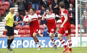 A Lee Tomlin brace helped Middlesborough see of Huddersfield.